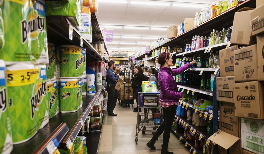 FILE - In this March 12, 2020, file photo, customers shop for cleaning products as market employees restock shelves in Aspen, Colo. Reports of accidental poisonings from cleaners and disinfectants are up sharply, and researchers believe it&#39;s related to the coronavirus epidemic. Such poisonings were up about 20 percent in the first three months of this year, compared to the same periods in 2018 and 2019.. The Centers for Disease Control and Prevention released the report Monday, April 20. (Kelsey Brunner/The Aspen Times via AP, File)