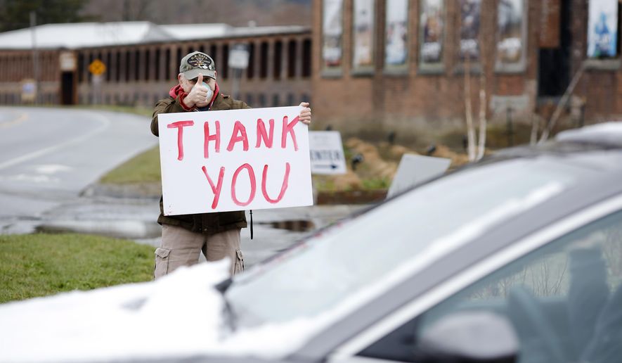 Francis Morandi stands outside the Greylock Works building in North Adams, Mass. thanking first responders, healthcare workers and truckers that lined up to receive free meals offered by M&J's Taste of Home Catering Company on Saturday, April 18, 2020. Morandi, a Vietnam veteran, said he is always thanked for his service, wanted to thank the first responders and healthcare workers. (Stephanie Zollshan/The Berkshire Eagle via AP)