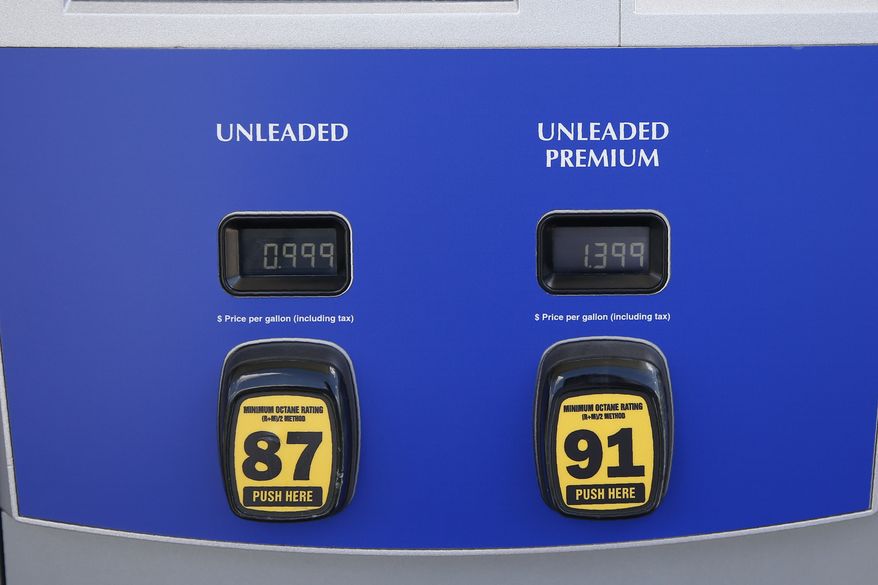 Gas prices are posted as .999 for regular and 1.37 for premium at a Sam's Club Tuesday, April 21, 2020, in Oklahoma City, as oil prices continue to drop, because very few people are flying or driving, and factories have shut amid widespread stay-at-home orders due to COVID-19. The new coronavirus causes mild or moderate symptoms for most people, but for some, especially older adults and people with existing health problems, it can cause more severe illness or death. (AP Photo/Sue Ogrocki)