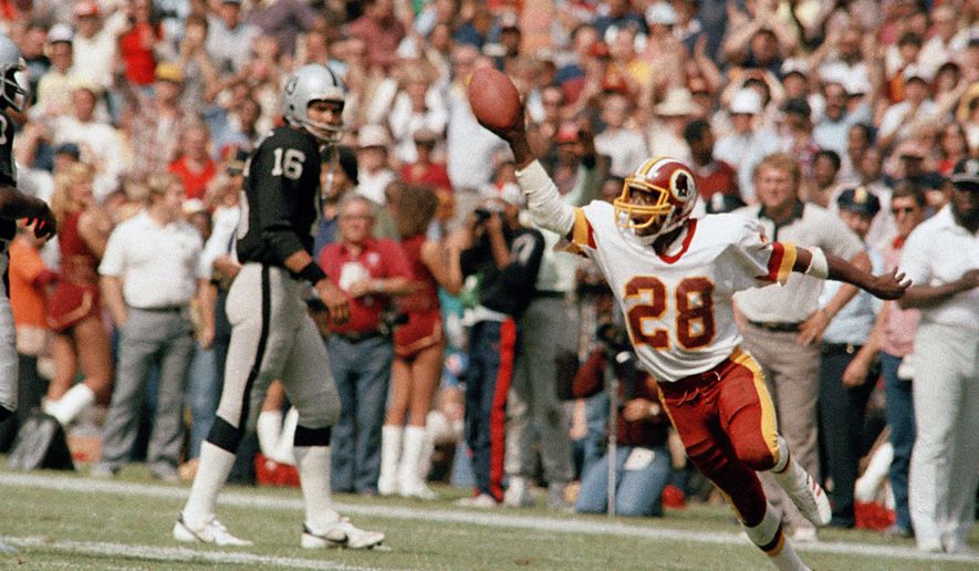 In this Oct. 2, 1983, file photo, Washington Redskins&#39; Darrell Green (28) reacts during an NFL football game against the Los Angeles Raiders in Washington. The Redskins have drafted nine Pro Football Hall of Famers and made plenty of big-time mistakes throughout franchise history. Cornerback Green became a building block for two Super Bowl-winning teams after being taken with the last pick in the first round in 1983. (AP Photo/Pete Wright, File)