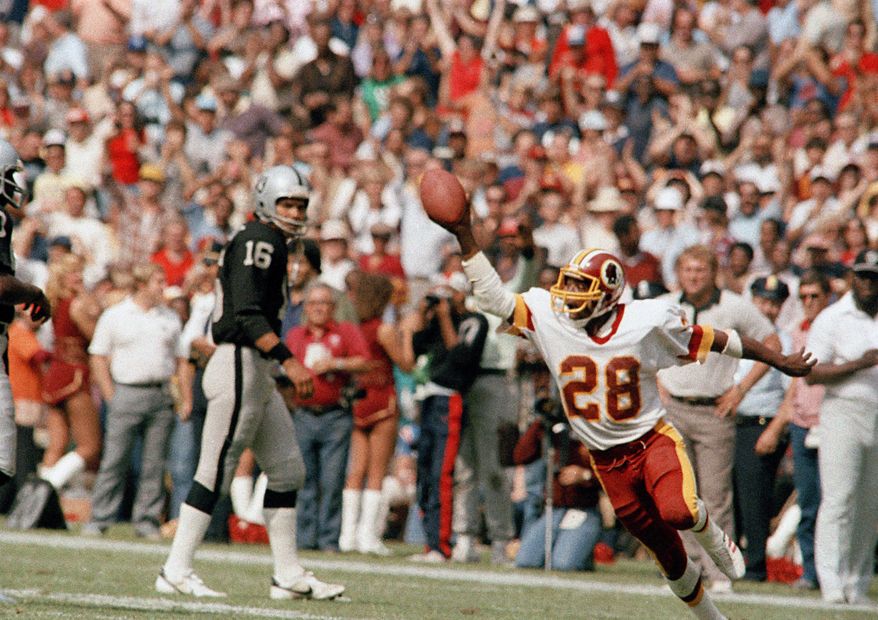 In this Oct. 2, 1983, file photo, Washington Redskins&#39; Darrell Green (28) reacts during an NFL football game against the Los Angeles Raiders in Washington. The Redskins have drafted nine Pro Football Hall of Famers and made plenty of big-time mistakes throughout franchise history. Cornerback Green became a building block for two Super Bowl-winning teams after being taken with the last pick in the first round in 1983. (AP Photo/Pete Wright, File)