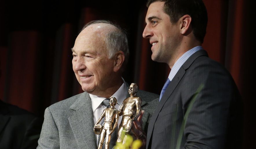 FILE - In this Jan. 31, 2014, file photo, legendary Green Bay Packers quarterback Bart Starr, left, presents current Packers quarterback Aaron Rogers, right, with the the Bart Starr Award for Character and Leadership at the Super Bowl Breakfast in New York. When Roger's stock took a draft-day plunge in 2005, the Packers scooped him up with the 24th overall selection. Starr, the 1956 17th-round draft pick from Alabama led the Packers to five NFL championships and was the MVP of the first two Super Bowls during a Hall of Fame career.(AP Photo/Ted S. Warren, File)