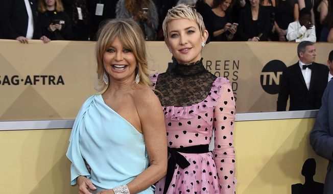 FILE - In this Jan 21, 2018 file photo, Goldie Hawn, left, and her daughter Kate Hudson arrive at the 24th annual Screen Actors Guild Awards in Los Angeles. Three generations will grace the cover of People magazine for the first time in its 30-year history. Goldie Hawn, her daughter Kate Hudson and granddaughter Rani Rose Fujikawa will appear on the cover of People’s “Beautiful Issue,” which will be released Friday. (Photo by Jordan Strauss/Invision/AP, File)