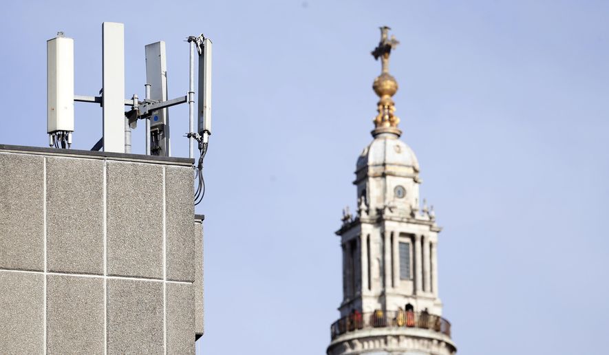 In this Tuesday, Jan 28, 2020, file photo, mobile network phone masts are visible in front of St Paul&#39;s Cathedral in the City of London. Dozens of European cell towers have been destroyed in recent arson attacks that officials and wireless companies say are fueled by groundless conspiracy theories linking new 5G mobile networks and the coronavirus pandemic. (AP Photo/Alastair Grant, File)