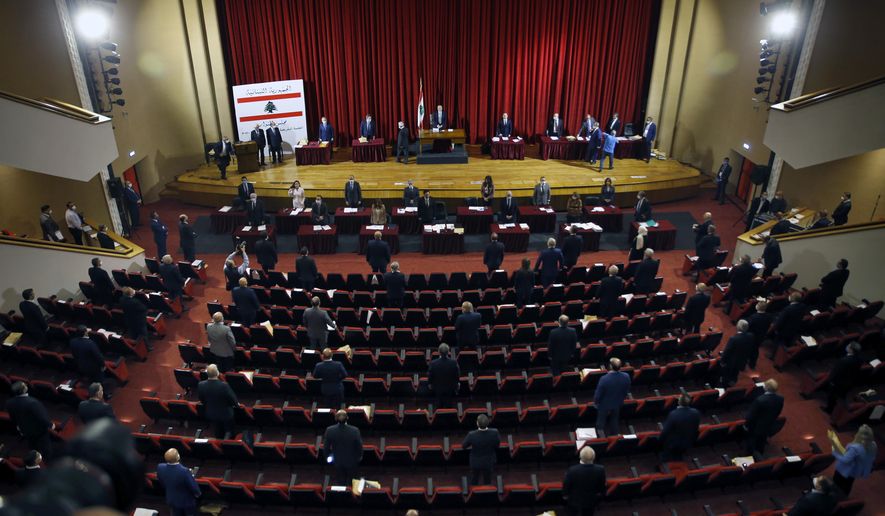 Lebanon's parliament began a three-day legislative session at a Beirut theater so that legislators can observe coronavirus social distancing measures, as protests against the country's ruling elite in the crisis-hit country resumed, in Beirut, Lebanon, Tuesday, April 21, 2020,. (AP Photo/Bilal Hussein)