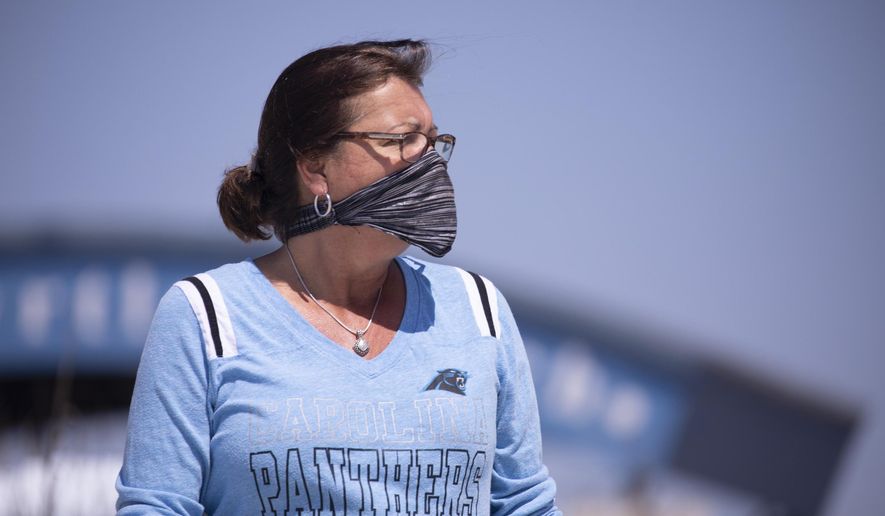 Angie Markey of North Myrtle Beach takes a look at the beach soon after it opened on Tuesday, April 21, 2020. North Myrtle Beach opened public beach accesses after Governor Henry McMaster removed his order allowing local municipalities to make their own decisions as of noon on Tuesday. (Jason Lee/The Sun News via AP)