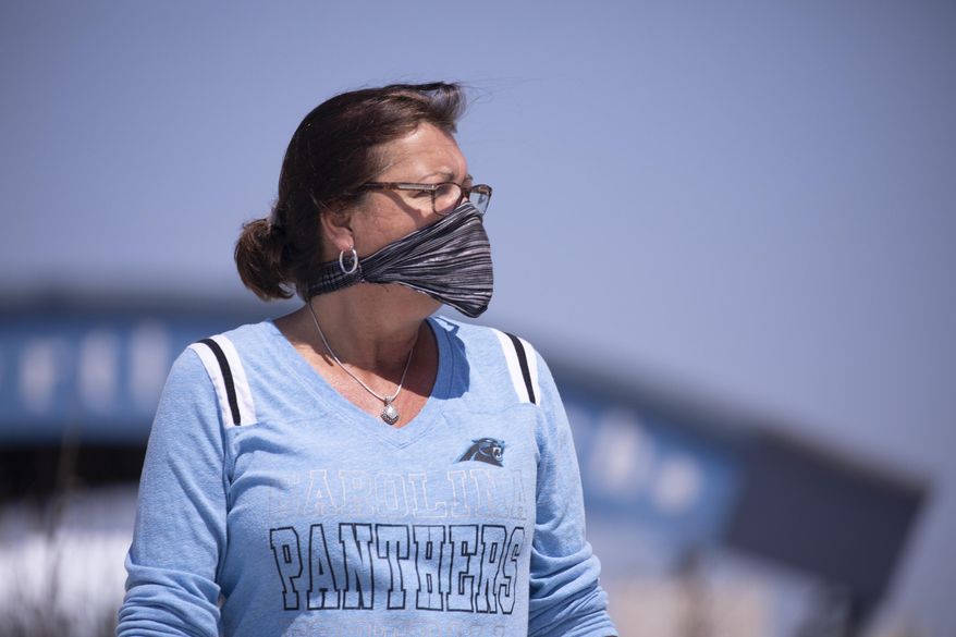 Angie Markey of North Myrtle Beach takes a look at the beach soon after it opened on Tuesday, April 21, 2020. North Myrtle Beach opened public beach accesses after Governor Henry McMaster removed his order allowing local municipalities to make their own decisions as of noon on Tuesday. (Jason Lee/The Sun News via AP)