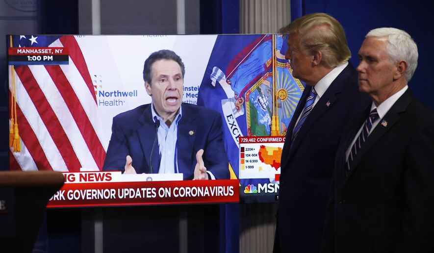Vice President Mike Pence, right, and President Donald Trump watch a video of New York Gov. Andrew Cuomo speaking during a coronavirus task force briefing at the White House, Sunday, April 19, 2020, in Washington. (AP Photo/Patrick Semansky)