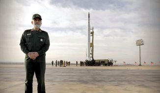 In this file photo released Wednesday, April 22, 2020, by Sepahnews, Gen. Amir Ali Hajizadeh, the head of the Revolutionary Guard&#39;s aerospace division, stands in front of an Iranian rocket carrying a satellite in an undisclosed site believed to be in Iran&#39;s Semnan province. The Guard said Wednesday it put the Islamic Republic&#39;s first military satellite into orbit, dramatically unveiling what experts described as a secret space program with a surprise launch that came amid wider tensions with the United States. (Sepahnews via AP) ** FILE **