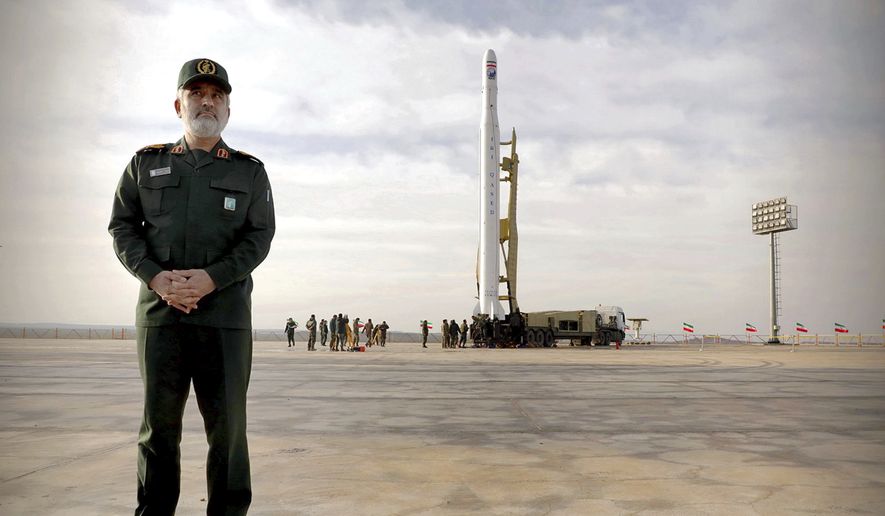 In this photo released Wednesday, April 22, 2020, by Sepahnews, Gen. Amir Ali Hajizadeh, the head of the Revolutionary Guard&#39;s aerospace division stands in front of an Iranian rocket carrying a satellite in an undisclosed site believed to be in Iran&#39;s Semnan province. The Guard said Wednesday it put the Islamic Republic&#39;s first military satellite into orbit, dramatically unveiling what experts described as a secret space program with a surprise launch that came amid wider tensions with the United States. (Sepahnews via AP)