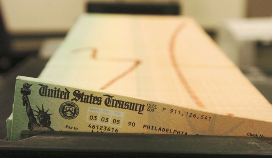 In this Feb. 11, 2005, file photo, trays of printed Social Security checks wait to be mailed from the U.S. Treasury&#39;s Financial Management services facility in Philadelphia. (AP Photo/Bradley C. Bower, File)