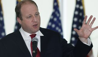 Colorado Governor Jared Polis speaks during a news conference to update the state&#x27;s efforts to stop the spread of the new coronavirus Wednesday, April 22, 2020, in Denver. (AP Photo/David Zalubowski)