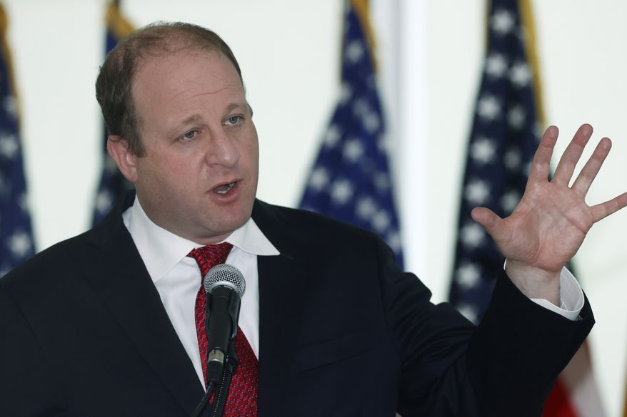Colorado Governor Jared Polis speaks during a news conference to update the state&#x27;s efforts to stop the spread of the new coronavirus Wednesday, April 22, 2020, in Denver. (AP Photo/David Zalubowski)