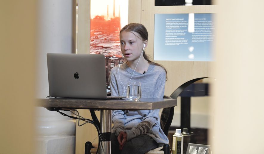 Environmental activist Greta Thunberg talks via video link with Professor of Environmental Science Johan Rockstrom in Germany, during a live chat on International Earth Day where they discussed the coronavirus pandemic and the environment, at the Nobel Museum in Stockholm, Sweden, Wednesday, April 22, 2020. (Jessica Gow/TT News Agency via AP)