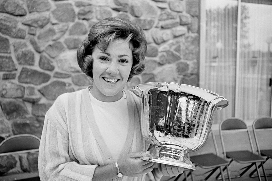 FILE - In this June 14, 1965, file photo, Susie Maxwell holds the silver trophy after winning the 36th annual Women's Western golf tournament in Chicago. Susie Maxwell Berning, one of six women to capture the U.S. Women's Open at least three times, was been elected to the World Golf Hall of Fame, Wednesday, April 22, 2020.(AP Photo/Larry Stoddard, File)