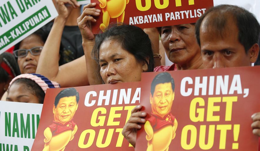 FILE - In this Nov. 21, 2018, file photo, demonstrators rally outside the Chinese Consulate to protest the two-day state visit in the country of President Xi Jinping in Manila, Philippines. The Philippines on Wednesday, April 22, 2020, has protested China’s declaration of a Manila-claimed South China Sea area as part of Chinese territory and the aiming of a weapon on a Philippine navy ship, the country’s top diplomat said Wednesday. (AP Photo/Bullit Marquez, File)