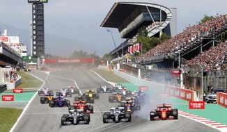 FILE - In this May 12, 2019 file photo, Mercedes driver Lewis Hamilton, left, of Britain leads the field after the start of the Spanish Formula One race at the Barcelona Catalunya racetrack in Montmelo, just outside Barcelona, Spain. Joan Fontsere, the general manager of the Circuit de Barcelona-Catalunya, says Formula One organizers are open to renegotiating hosting fees for races that may take place without fans this season because of the coronavirus pandemic. (AP Photo/Joan Monfort, File)