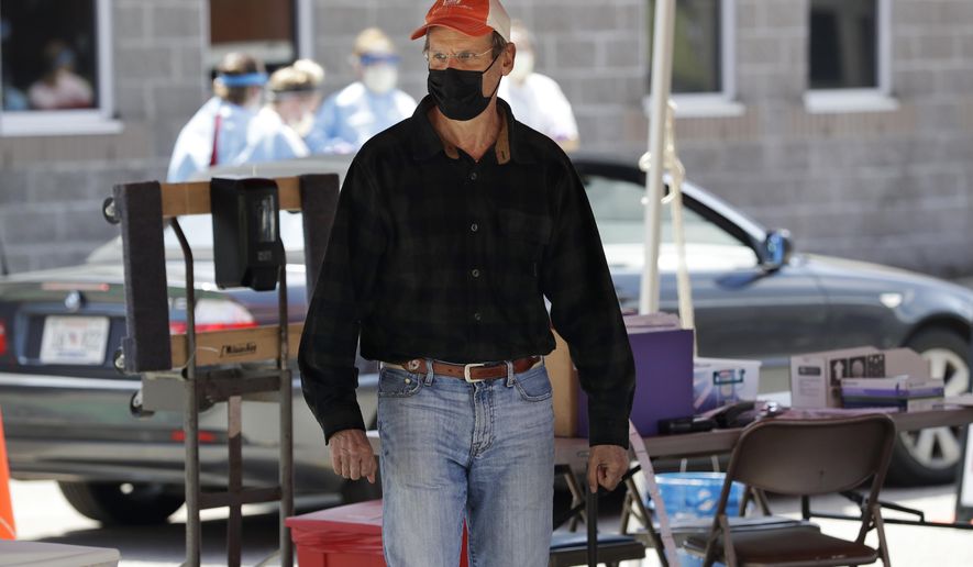FILE - In this April 18, 2020, file photo, Tennessee Gov. Bill Lee visits a drive-thru COVID-19 testing location in Franklin, Tenn. Lee announced Monday, April 20, that most businesses will begin resuming operations as soon as next week. (AP Photo/Mark Humphrey, File)