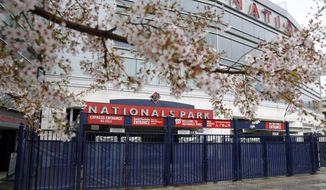 This Wednesday, March 25, 2020, photo shows closed gates at Nationals Park in Washington. With the start of the Major League Baseball season indefinitely on hold because of the novel coronavirus pandemic, ballparks will be empty Thursday on what was supposed to be opening day.  (AP Photo/Patrick Semansky)