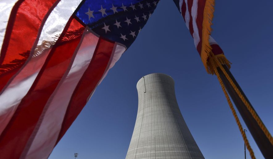 In this March 22, 2019, file photo an American flag flies on a construction site at Alvin W. Vogtle Electric Generating Plant, a nuclear power plant, in Waynesboro, Ga. Sen. John Barrasso of Wyoming called Sunday for shutting down imports of Russian uranium and increasing U.S. production, arguing that the sales are propping up Russian President Vladimir Putin&#x27;s attack on Ukraine. (Hyosub Shin/Atlanta Journal-Constitution via AP)