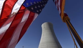 In this March 22, 2019, file photo an American flag flies on a construction site at Alvin W. Vogtle Electric Generating Plant, a nuclear power plant, in Waynesboro, Ga. Sen. John Barrasso of Wyoming called Sunday for shutting down imports of Russian uranium and increasing U.S. production, arguing that the sales are propping up Russian President Vladimir Putin&#39;s attack on Ukraine. (Hyosub Shin/Atlanta Journal-Constitution via AP)