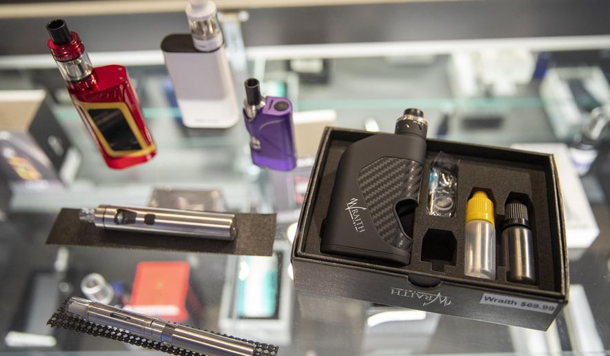 FILE - In this Thursday, Jan. 2, 2020 file photo, vaping devices are displayed at a store in New York. On Thursday, April 23, 2020, the U.S. Food and Drug Administration said that a federal court accepted its request to push back the May 12 deadline to submit vaping product applications to Sept. 9. The agency said the COVID-19 pandemic has delayed preparations to meet the deadline for both companies and FDA staff. (AP Photo/Mary Altaffer)