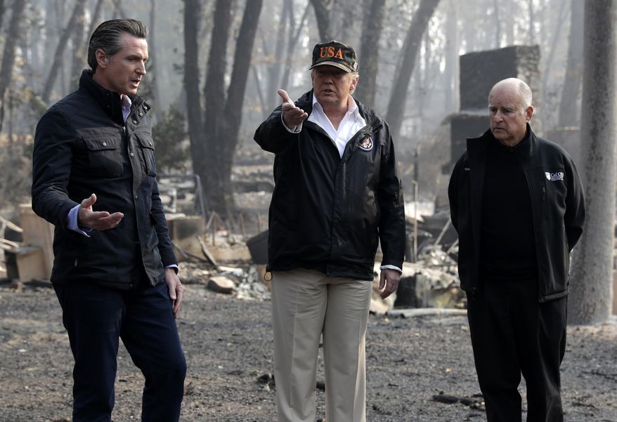 FILE - In this Nov. 17, 2018 file photo President Donald Trump talks with Gov.-elect Gavin Newsom, left, and as California Gov. Jerry Brown listens during a visit to a neighborhood impacted by the wildfires in Paradise, Calif. Newsom and Trump, who are often critical of each other, are getting along during the coronavirus pandemic. (AP Photo/Evan Vucci, File)