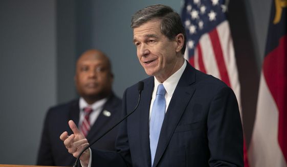 North Carolina Gov. Roy Cooper announces that his stay-at-home order will be extended until May 8 during a press briefing on the coronavirus, Thursday, April 23, 2020, at the Emergency Operations Center in Raleigh, N.C. (Robert Willett/The News &amp;amp; Observer via AP)  **FiLE**