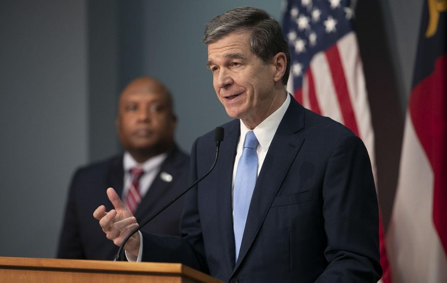 North Carolina Gov. Roy Cooper announces that his stay-at-home order will be extended until May 8 during a press briefing on the coronavirus, Thursday, April 23, 2020, at the Emergency Operations Center in Raleigh, N.C. (Robert Willett/The News & Observer via AP) **FiLE**