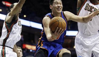 FILE - This March 9, 2012 file photo shows New York Knicks&#39; Jeremy Lin shooting between Milwaukee Bucks&#39; Shaun Livingston, left, and Larry Sanders during the first half of an NBA basketball game in Milwaukee. Linsanity is finally getting another run on MSG Network. In search of content to fill with no games because of the coronavirus, the network is turning to Jeremy Lin’s memorable NBA breakthrough, which was once ratings gold. The network said Friday, April 24, 2020 it will dedicate a week of programming to the 2012 stretch when Lin got his chance with the New York Knicks and took the league by storm.(AP Photo/Morry Gash, File)