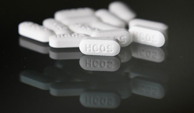 FILE - This Monday, April 6, 2020 file photo shows an arrangement of hydroxychloroquine pills in Las Vegas.At least 13 states have obtained a total of more than 10 million doses of malaria drugs to treat COVID-19 patients despite warnings from doctors that more tests are needed before the medications that President Trump once fiercely promoted should be used to help people with the coronavirus. (AP Photo/John Locher,File)