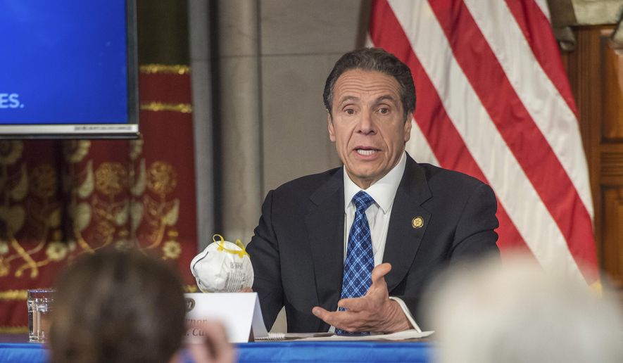 In this April 24, 2020, file photo provided by the Office of Governor Andrew M. Cuomo, Gov. Cuomo addresses the media while holding an N95 mask during his daily press briefing on COVID-19, Coronavirus, at the State Capitol in Albany, N.Y. The mask was sent to the governor by a retired farmer from Kansas whose wife only has one lung. (Darren McGee/Office of Governor Andrew M. Cuomo via AP)