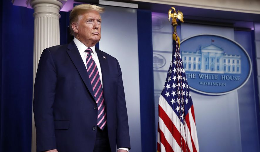 President Donald Trump listens as Vice President Mike Pence speaks about the coronavirus in the James Brady Press Briefing Room of the White House, Friday, April 24, 2020, in Washington. (AP Photo/Alex Brandon)