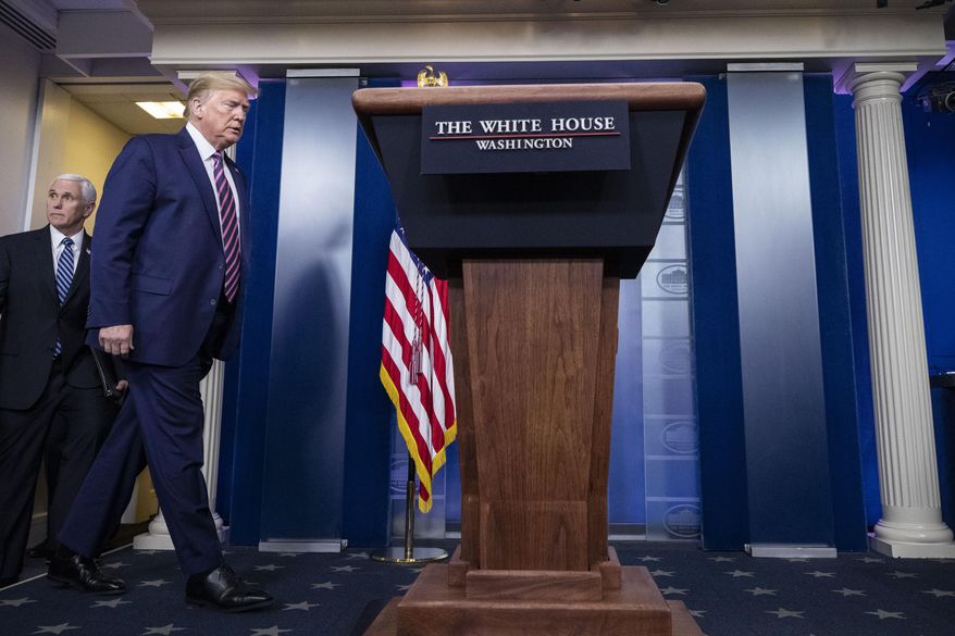 President Donald Trump, followed by Vice President Mike Pence, arrives to speak about the coronavirus in the James Brady Press Briefing Room of the White House, Friday, April 24, 2020, in Washington. (AP Photo/Alex Brandon)