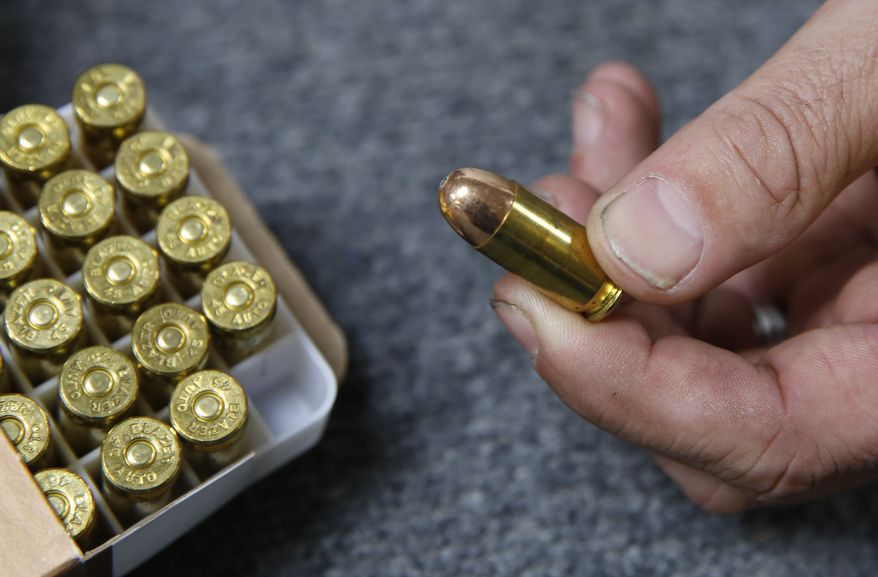 In this June 11, 2019, file photo, Chris Puehse, owner of Foothill Ammo, displays .45-caliber ammunition for sale at his store in Shingle Springs, Calif. An appeals court on Friday, April 24, 2020, has reinstated a California law requiring background checks for people buying ammunition, reversing a federal judges decision to stop the checks that he said violate the constitutional right to bear arms. The law, which took effect last July, requires Californians to pass an in-store background check before buying ammunition, which involves running buyers names through a California Department of Justice database that tracks legal purchases of guns. (AP Photo/Rich Pedroncelli, File)
