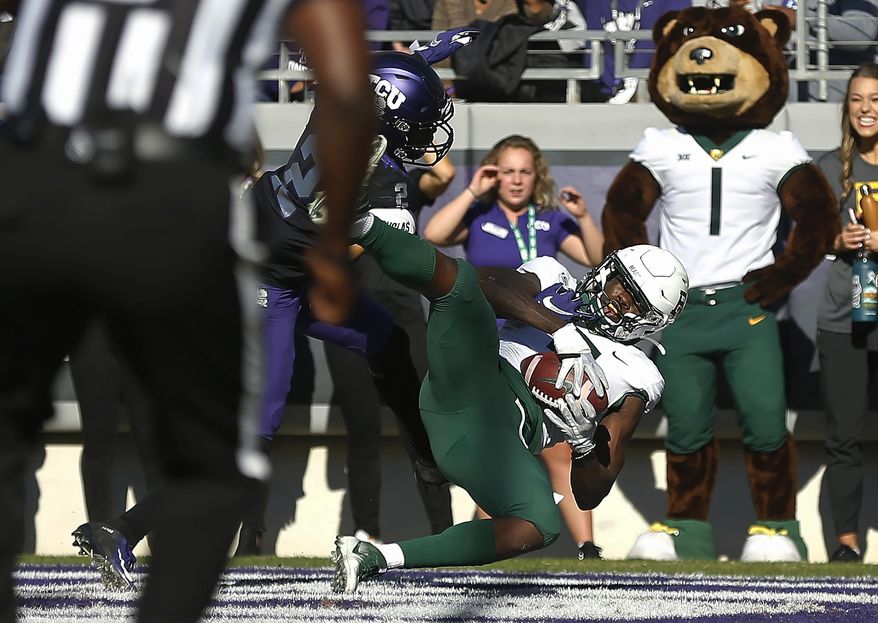 FILE - In this Nov. 9, 2019, file photo, Baylor wide receiver Denzel Mims (5) catches a touchdown pass as TCU cornerback Kee'yon Stewart (2) defends during the third overtime of an NCAA college football game in Fort Worth, Texas. Mims was selected by the New York Jets in the second round of the NFL football draft Friday, April 24, 2020. (AP Photo/Ron Jenkins, File)