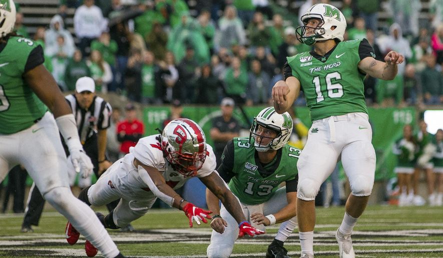 In this Oct. 26, 2019, file photo, Marshall kicker Justin Rohrwasser (16) hits a 53-yard game winning field goal against Western Kentucky during an NCAA college football game in Huntington, W.Va. New Patriots kicker Justin Rohrwasser says a tattoo on his arm is not representative of a loosely organized right-wing militia group that has adopted the symbol. Rohrwasser, who played at Rhode Island and Marshall, was taken 159th overall in the fifth round of the draft Saturday, April 25, 2020.(Sholten Singer/The Herald-Dispatch via AP) ** FILE **
