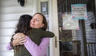 Holly Balcom, 54, hugs her daughter Kelsea Mensh, 22, as they reunite at their home in Dumfries, Va., Wednesday, April 1, 2020, after Mensh, who had served a year in the Peace Corps in the Dominican Republic, finished her 2 week quarantine period. After evacuating her from her post, the Peace Corps put Mensh up in a hotel in her hometown to self-isolate so that she wouldn&#39;t cause any risk to her mother, who is a cancer survivor and has viral induced asthma. Though she is grateful to have been evacuated, &amp;quot;I didn&#39;t get to say goodbye,&amp;quot; says Mensh, who is very worried about the community she had to leave in the Dominican Republic, &amp;quot;I told my mother that in tears and we both started to cry. She said, &#39;I didn&#39;t get to say goodbye to the children here either.&#39;&amp;quot; Balcom is a fourth grade teacher. (AP Photo/Jacquelyn Martin)
