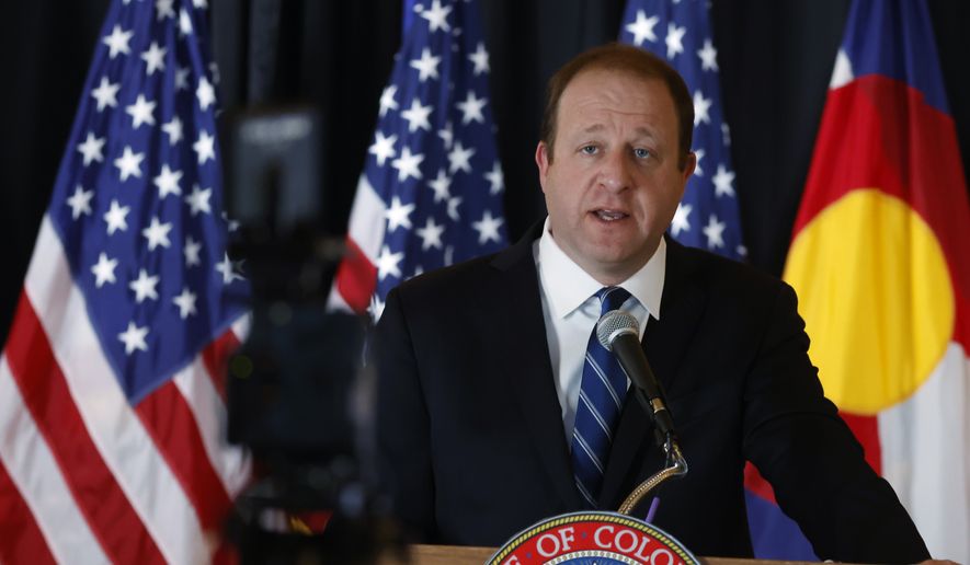 Colorado Gov. Jared Polis makes a point during a news conference about the state's efforts to reopen non-essential businesses while still dealing with the dangers of the new coronavirus Monday, April 27, 2020, in the State Capitol in Denver. (AP Photo/David Zalubowski) ** FILE **
