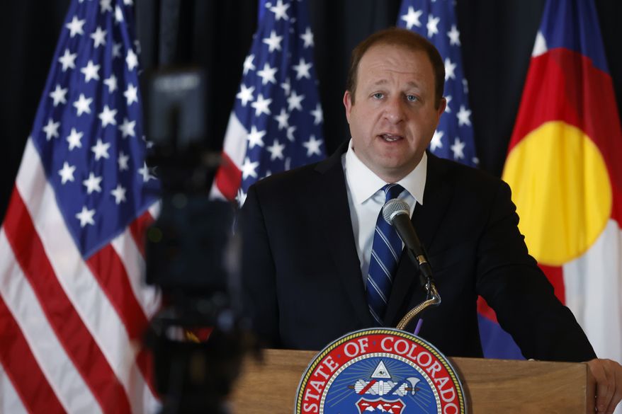 Colorado Gov. Jared Polis makes a point during a news conference about the state's efforts to reopen non-essential businesses while still dealing with the dangers of the new coronavirus Monday, April 27, 2020, in the State Capitol in Denver. (AP Photo/David Zalubowski) ** FILE **