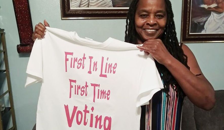 In this photo taken by her son, Betty Riddle in Sarasota, Fla., Sunday, April 26, 2020, holds the T-shirt she wore on March 17, 2020, when she voted for the first time. She was barred from voting in Florida until a federal judge temporarily blocked the state from preventing her and 16 other felons from voting because of unpaid legal financial obligations. (Courtesy of Rickie Riddle via AP)