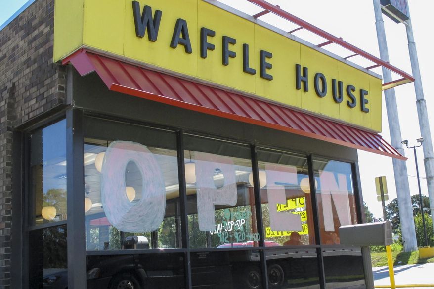 In this file photo, a Waffle House restaurant has 'OPEN' painted across its windows on Monday, April 27, 2020 in Savannah, Georgia. (AP Photo/Russ Bynum) **FILE**