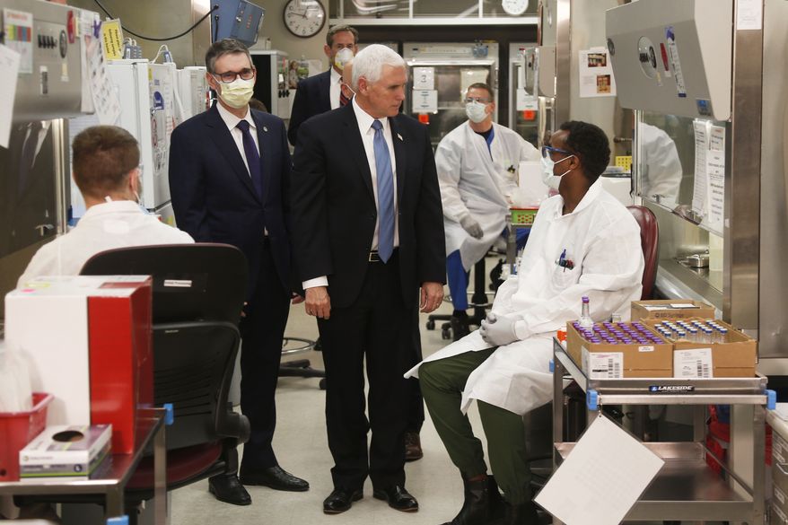 Vice President Mike Pence visits the molecular testing lab at Mayo Clinic Tuesday, April 28, 2020, in Rochester, Minn., where he toured the facilities supporting COVID-19 research and treatment. Pence chose not to wear a face mask while touring the Mayo Clinic in Minnesota. It's an apparent violation of the world-renowned medical center's policy requiring them. (AP Photo/Jim Mone)