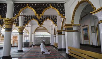 An Indian Muslim man prays in a Mosque during the nationwide lockdown to prevent the spread of new coronavirus in Gauhati, India, Monday, April 27, 2020. The U.S. Commission on International Religious Freedom is urging that the State Department add India to its list of nations with uniquely poor records on protecting freedom to worship, while proposing to remove Sudan and Uzbekistan from that list. (AP Photo/Anupam Nath)