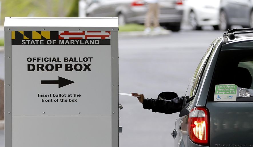 A motorist drops off a mail-in ballot outside of a voting center during the 7th Congressional District special election, Tuesday, April 28, 2020, in Windsor Mill, Md. The state election board says that voters will be able to drop their general-election ballots at hundreds of drop boxes instead of mailing them or casting them in person. 
 (AP Photo/Julio Cortez)