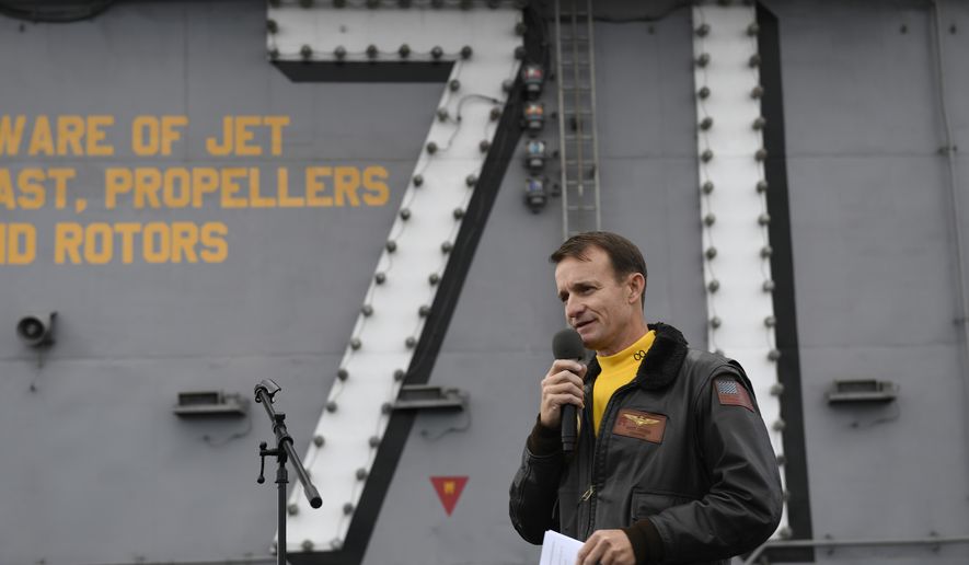 In this Nov. 15, 2019, photo U.S. Navy Capt. Brett Crozier, then commanding officer of the aircraft carrier USS Theodore Roosevelt (CVN 71), addresses the crew during an all-hands call on the ship&#39;s flight deck while conducting routine operations in the Eastern Pacific Ocean.  (U.S. Navy Photo by Mass Communication Specialist 3rd Class Nicholas Huynh via AP)