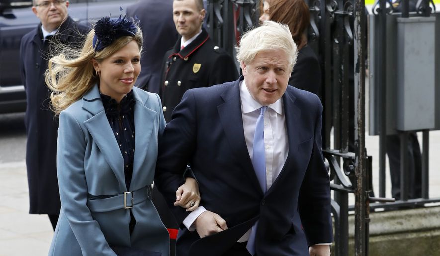 In this Monday, March 9, 2020, file photo Britain's Prime Minister Boris Johnson and his partner Carrie Symonds arrive to attend the annual Commonwealth Day service at Westminster Abbey in London. (AP Photo/Kirsty Wigglesworth, File)