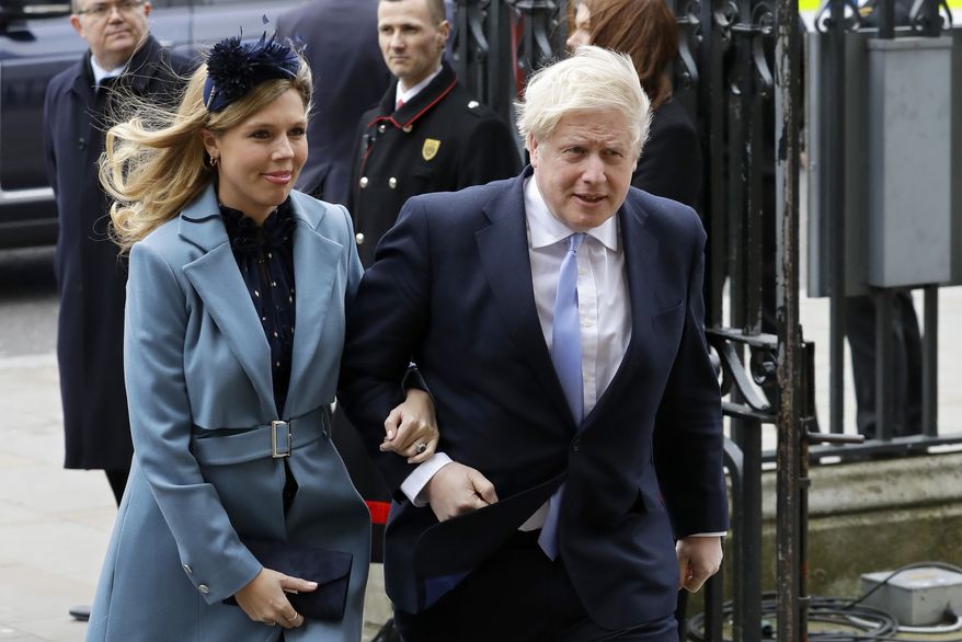 In this Monday, March 9, 2020, file photo Britain's Prime Minister Boris Johnson and his partner Carrie Symonds arrive to attend the annual Commonwealth Day service at Westminster Abbey in London. (AP Photo/Kirsty Wigglesworth, File)