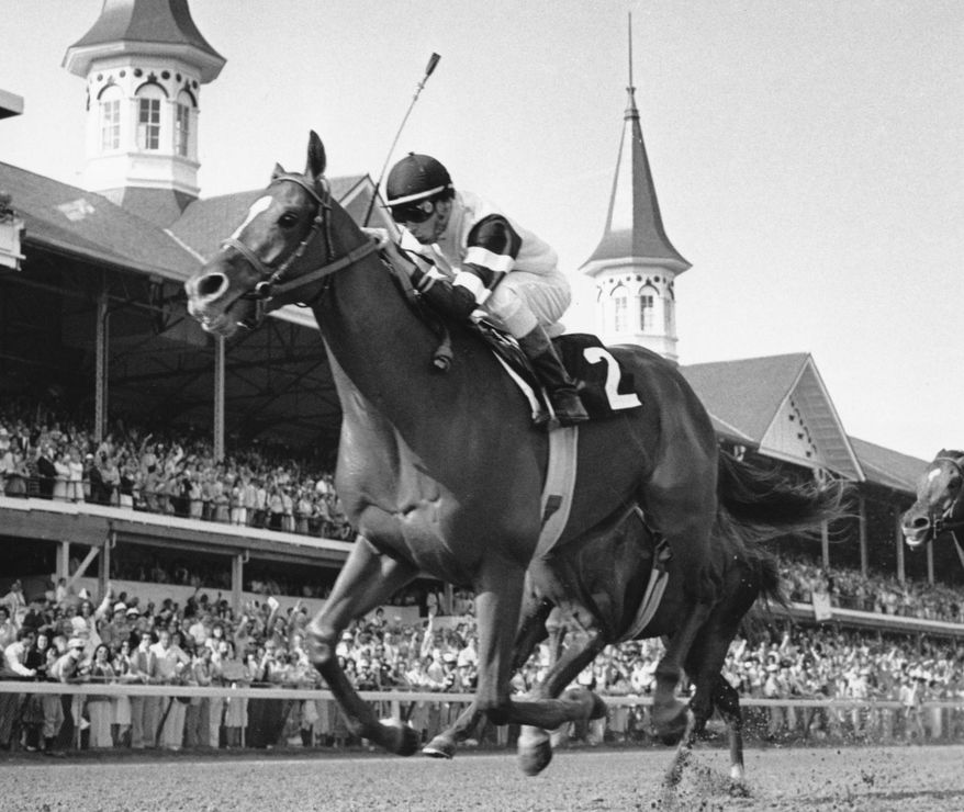 In this May 6, 1978, file photo, Affirmed, jockey Steve Cauthen up, crosses the finish line to win the Kentucky Derby in Louisville, Ky. Secretariat is the early 7-2 favorite for this weekend’s virtual Kentucky Derby, an animated race pitting all 13 Triple Crown winners on the day the Derby would have been held before the coronavirus pandemic postponed it. Citation, who won the 1948 Triple Crown, was made the 4-1 second choice. Seattle Slew and Affirmed, the 1977 and '78 Triple Crown winners, were each listed at 5-1 odds. (AP Photo/File) **FILE**