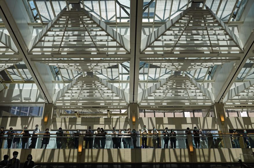 Protestors wear face masks gather at a shopping mall in Hong Kong, Wednesday, April 29, 2020. Demonstrators gathered in a luxury mall chanting pro-democracy slogans, the latest in a string of protests over the past week. (AP Photo/Vincent Yu)